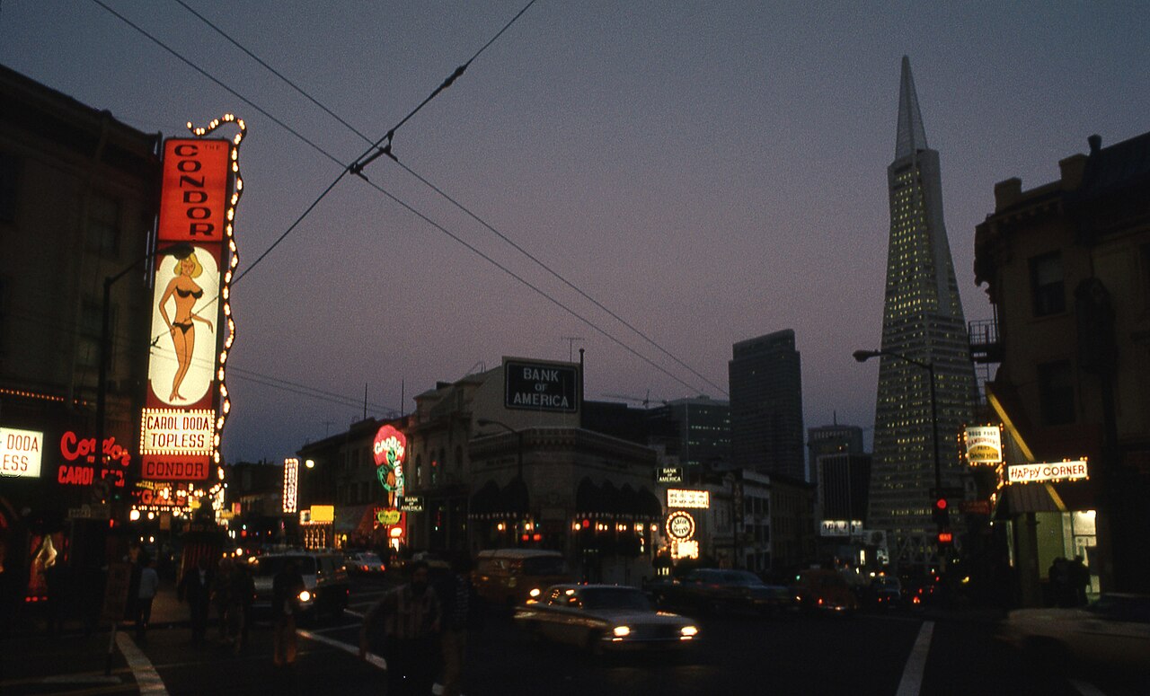 Carol Doda and the Condor's neon, 1973, the new Transamerica Pyramid rising behind