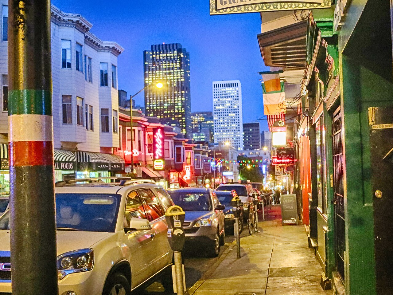 Grant Avenue at twilight, the strip's tricolor poles lit against downtown